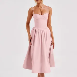 Elegant detail showing the bustier bodice of a French retro light pink midi dress