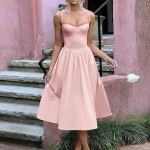 Elegant French vintage pink bustier midi dress with pleated skirt detail in a garden setting