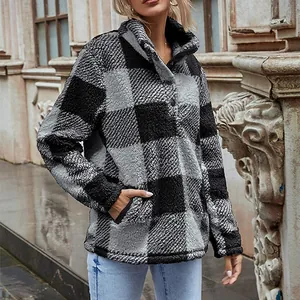 Close-up of a black and grey buffalo plaid fleece pullover with button stand collar.