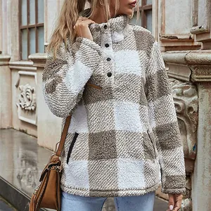 Cozy women's plaid fleece pullover featuring buttoned stand collar and soft texture.