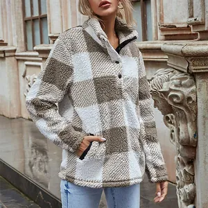 Warm and cozy brown plaid fleece pullover featuring a soft funnel neck and functional button detail