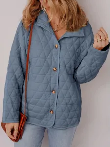 Detailed macro view of a light blue quilted autumn jacket with elegant diamond stitching