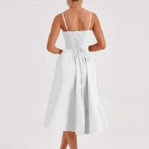 Back detail of white French vintage midi dress with elegant corset lace-up design.