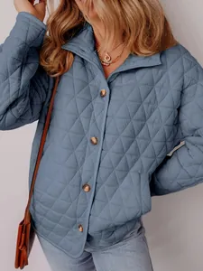 Close-up of a blue diamond quilted jacket with elegant button detailing for winter