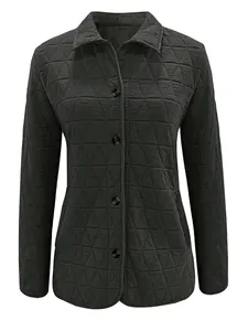 Macro view of a dark grey quilted jacket showing its intricate geometric triangle patterns.