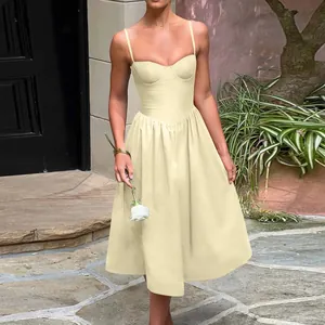 Model wearing a French vintage yellow midi dress with a corset bodice in an outdoor setting