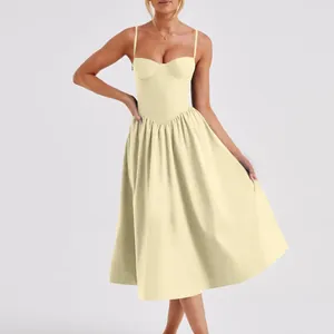 Elegant French vintage style pale yellow spaghetti strap midi dress shown on model