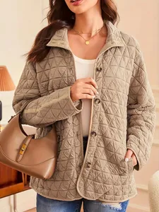 Detail of a minimalist beige quilted cotton coat featuring a diamond pattern for women