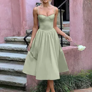 Full length view of a sage green vintage midi dress on a model in an outdoor setting