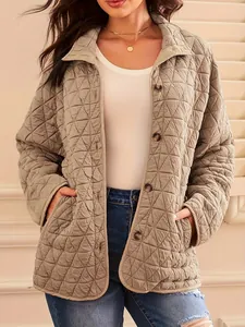 Detail view of khaki quilted jacket featuring triangle pattern and button closure