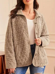 Close-up detail of a stylish khaki quilted jacket featuring triangle patterns and buttons