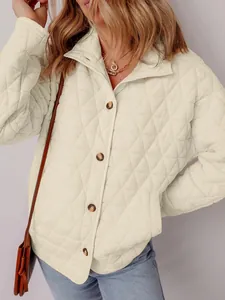 Close-up of women's cream quilted cotton jacket with minimalist triangle pattern