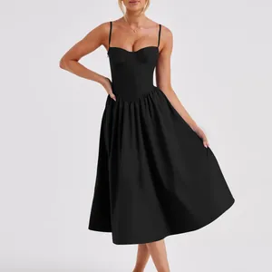 Elegant black corset bodice with spaghetti straps on a French vintage pleated dress