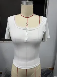 Close-up of white ribbed slim fit short sleeve top with delicate lace trim and buttons