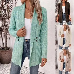 Detail view of women's long knit cardigan with decorative buttons and multiple color variations.