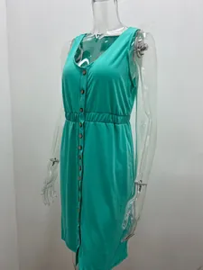 Side view of a sleeveless turquoise mini dress with button detail on a clear mannequin
