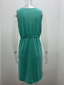 Detailed rear view of a solid green sleeveless dress with an elasticated waistline.