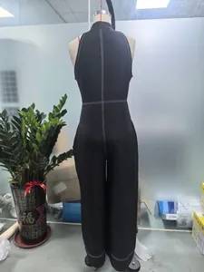 Close-up of the back of a black sleeveless jumpsuit with white contrast stitching