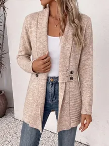 Close-up of beige knitted mid-length cardigan with decorative button straps
