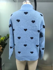 Vista trasera detallada de un jersey de punto azul claro con corazones negros en un maniquí.