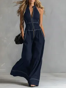 Full view of women's dark blue halter neck jumpsuit with white contrast stitching