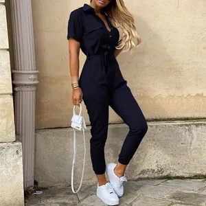 Detailed view of navy blue short sleeve utility jumpsuit with lapel and waist tie.