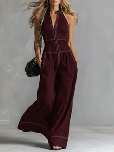 Elegant burgundy sleeveless wide-leg jumpsuit with contrast stitching and zipper front detail.