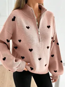 Elegante suéter de punto rosa con media cremallera, motivos de corazones negros y puños.