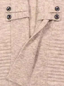 Detailed macro view of beige knitted cardigan texture with decorative button straps