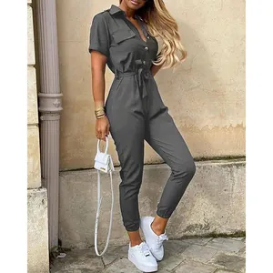 Full view detail of grey short-sleeved utility jumpsuit with waist tie and buttons