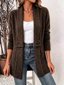 Close-up of a women's brown knitted cardigan with decorative waist buttons and textured patterns.