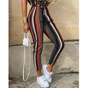 Vertical stripe lapel button-down jumpsuit with waist belt shown in a street style shot