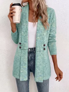 Close-up detail of a mint green knit cardigan featuring double-breasted decorative straps