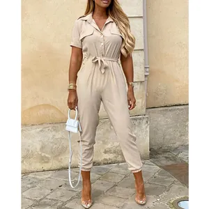 Full view of a beige short-sleeve jumpsuit with a collar and waist tie for women