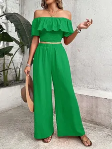 Stylish two-piece green off-shoulder ruffle crop top and wide leg pants set for women
