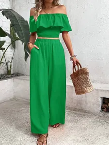 Detailed view of green off-the-shoulder ruffle top and matching wide-leg pants set