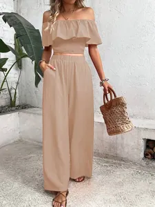 Chic two-piece set featuring off-the-shoulder smocked crop top and matching wide-leg trousers