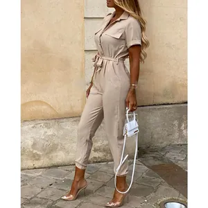 Side view detail of a beige short sleeve utility jumpsuit with button closure and waist tie
