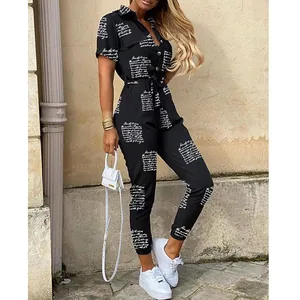 Full view detail of a women's black printed lapel jumpsuit with buttons and a belt