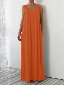 Full length view showing the loose fit and side pocket detail of this orange dress