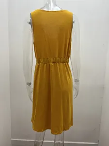 Back view of a sleeveless yellow dress with an elastic waist on a transparent mannequin.