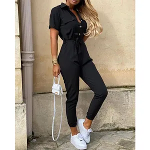 Full-body view of a stylish black short-sleeved cargo jumpsuit with lapel and tie-waist belt