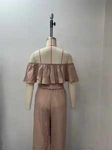 Detailed back view of solid color off-shoulder ruffle top and wide-leg pants set on mannequin
