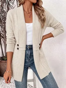 Detailed view of cream knit cardigan featuring decorative double-breasted waist straps