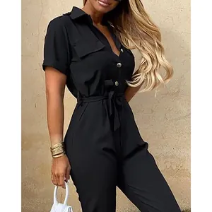Close-up detail of women's black short-sleeve button-down jumpsuit with waist tie