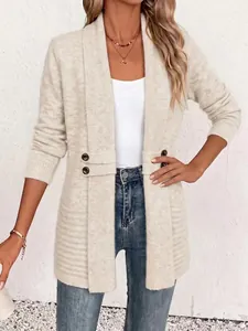 Detail of cream knit cardigan with double-breasted decorative waist buttons