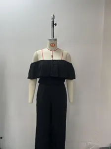 Full view of black off-the-shoulder ruffle top and wide-leg pants on a dress form.