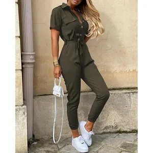 Side view of woman wearing olive green short sleeve utility jumpsuit with belt