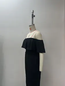 Detailed side view of a black off-shoulder ruffle top and wide-leg trousers on a mannequin.