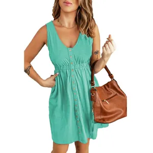 Chic sleeveless button-down green mini dress with elastic waist shown on model with bag